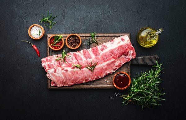Chef plating a pork dish